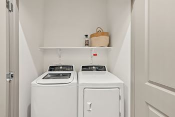 A small laundry room with a washer and dryer.